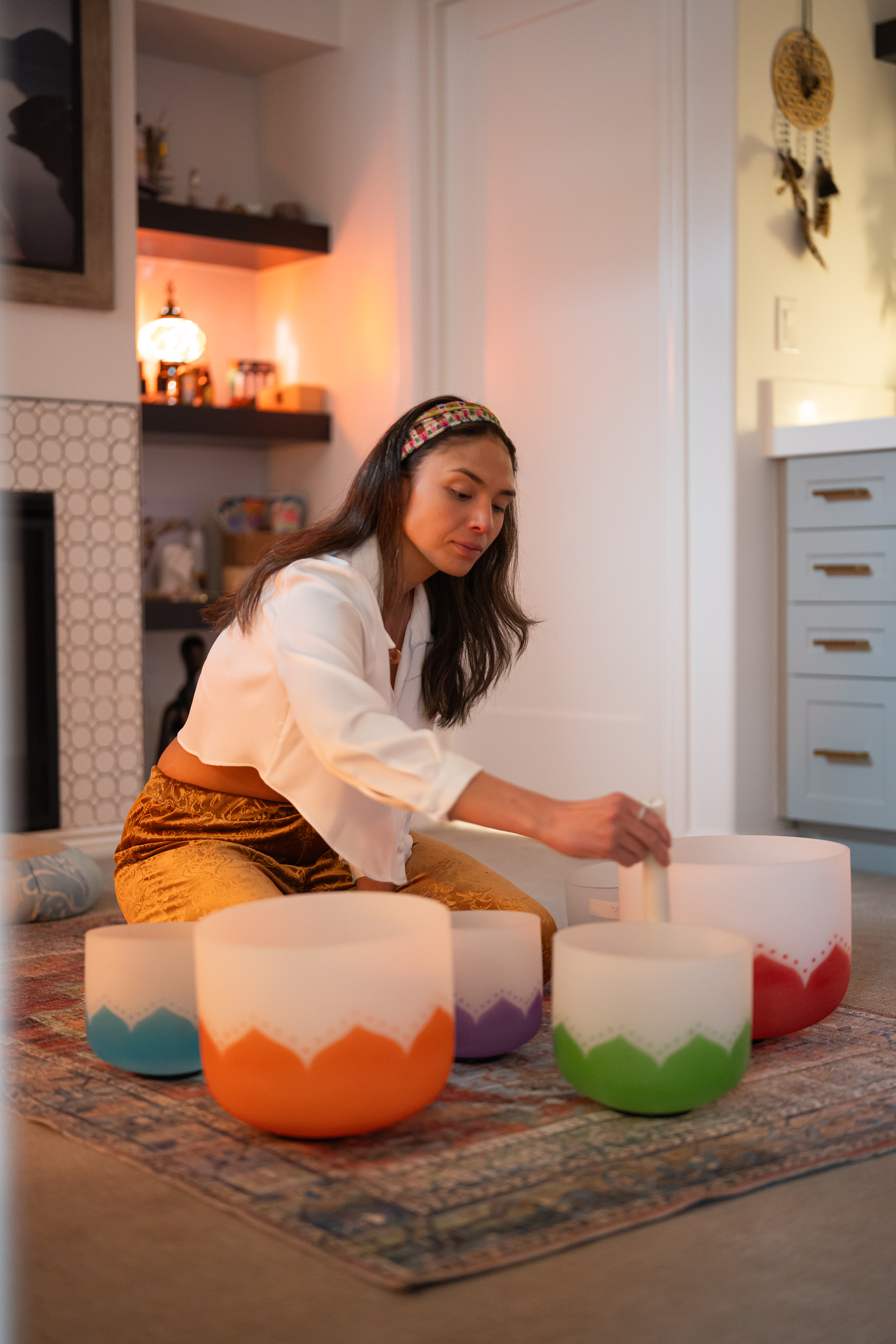 Kels Kyle facilitating a ceremony with a drum